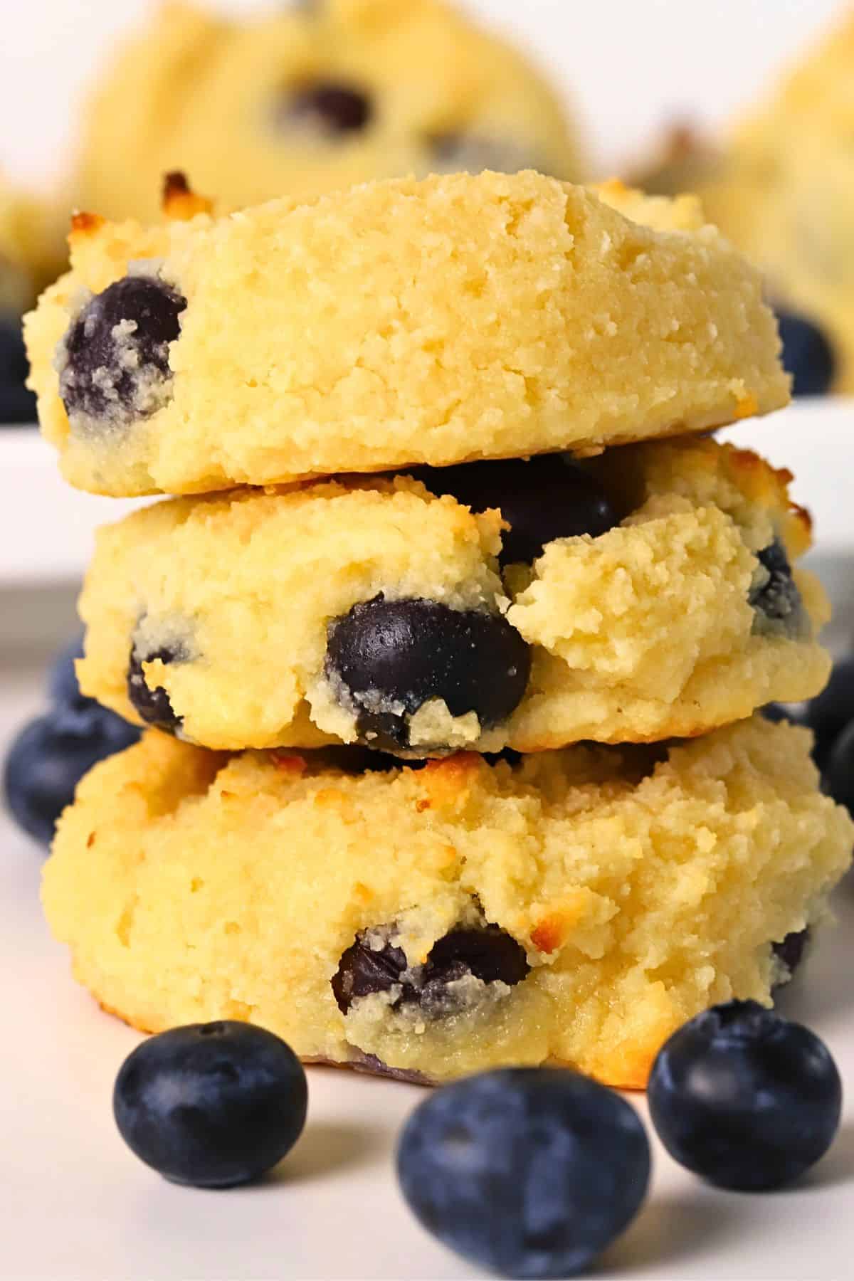Three low carb blueberry cottage cheese cookies stacked on top of each other.