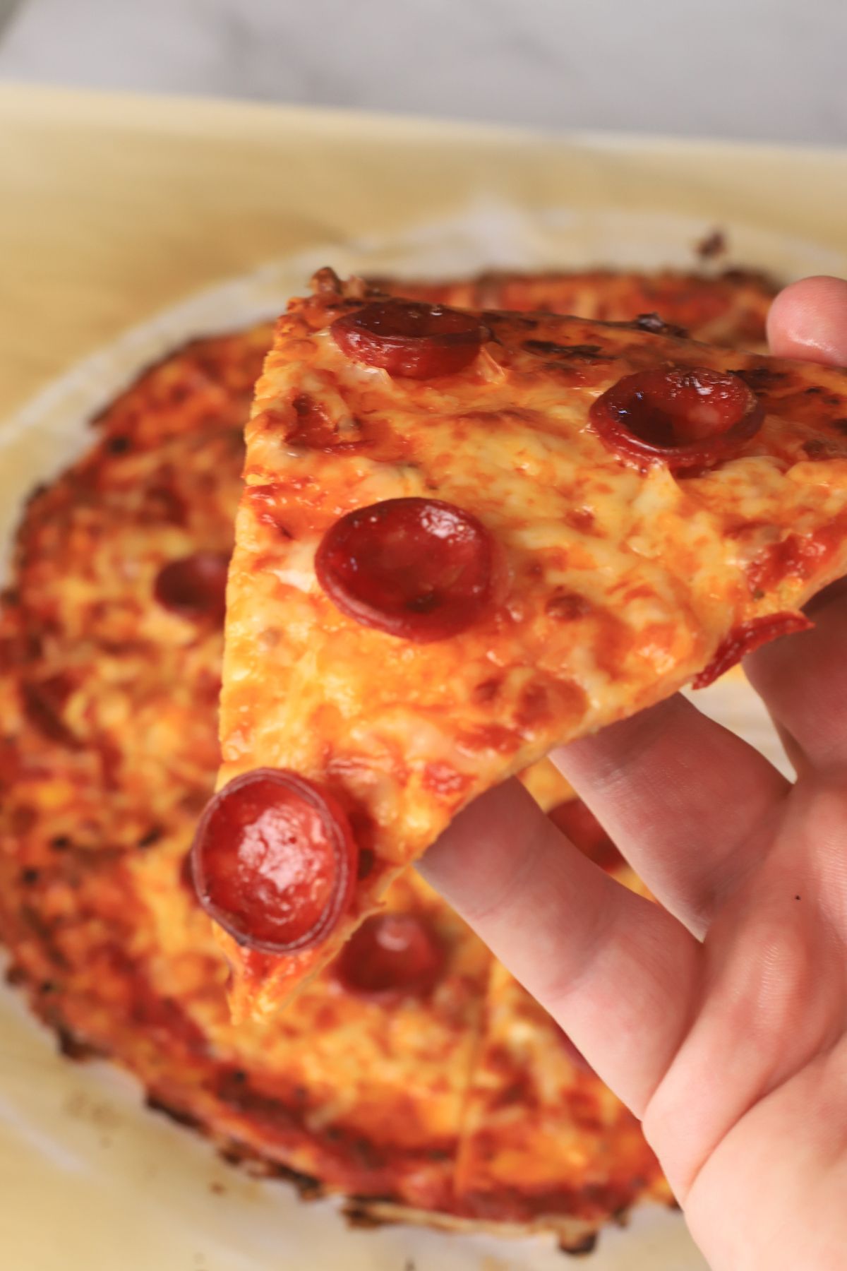 Holding a slice of pizza.