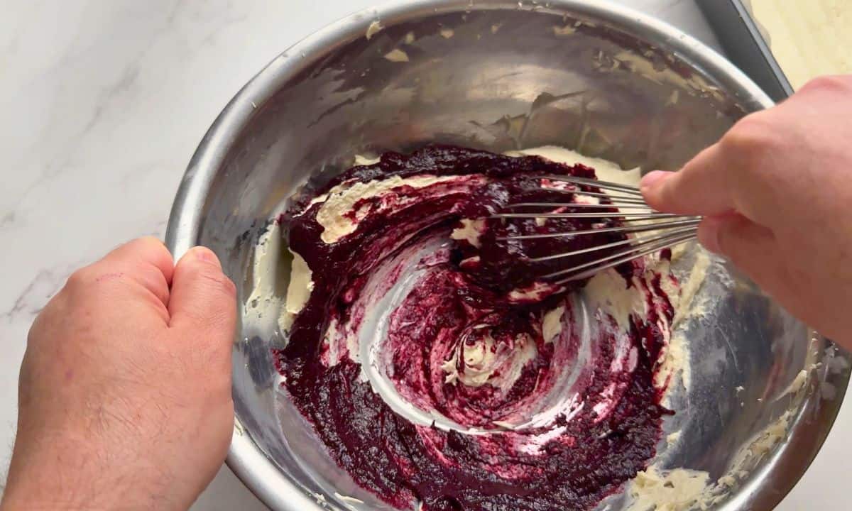 Mixing the blueberry puree with the cream cheese.