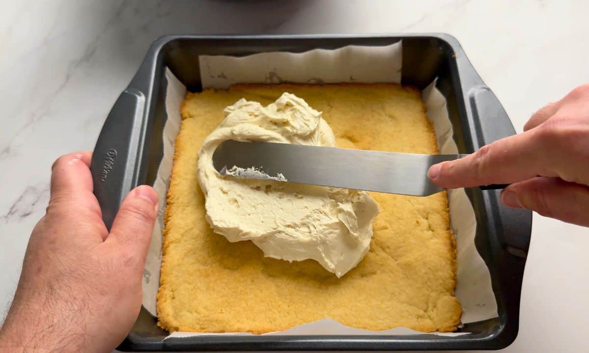 Laying the cream cheese layer onto the crust.
