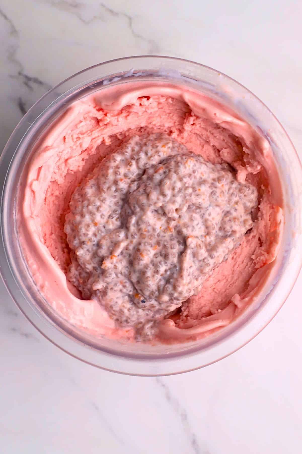 Low carb raspberry chia cottage cheese ice cream in a ninja creamipint topped with the raspberry chia mixture.