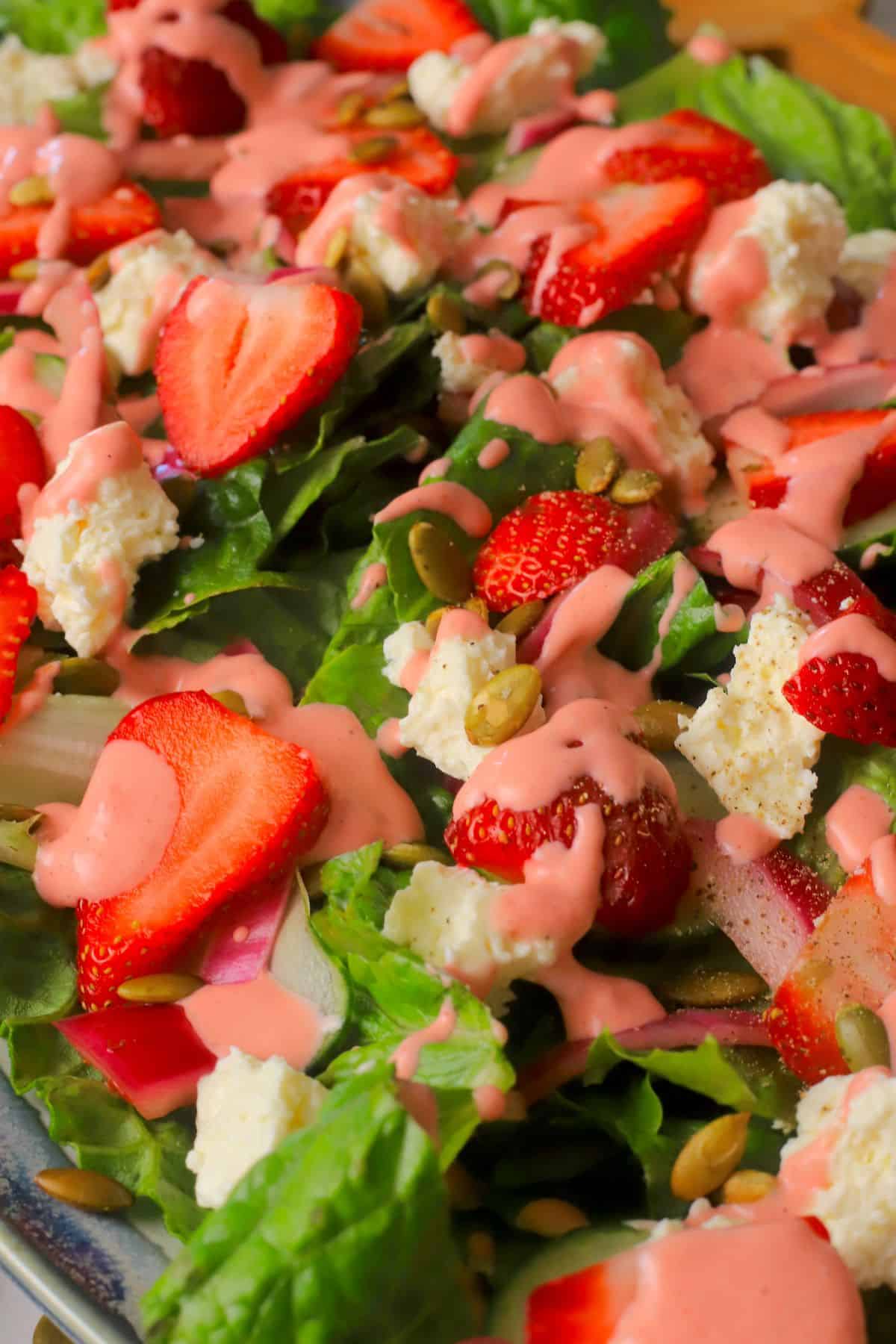 Close up image of the strawberry feta salad with strawberry dressing.