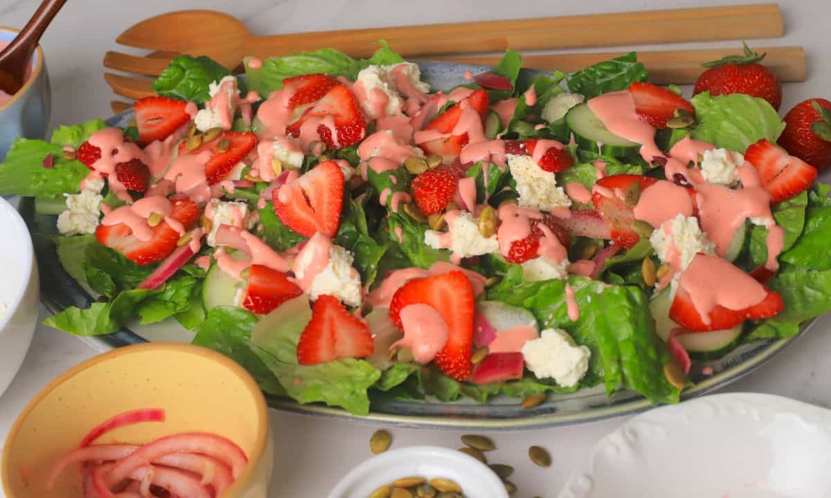 Low carb strawberry feta salad with strawberry dressing on a platter.