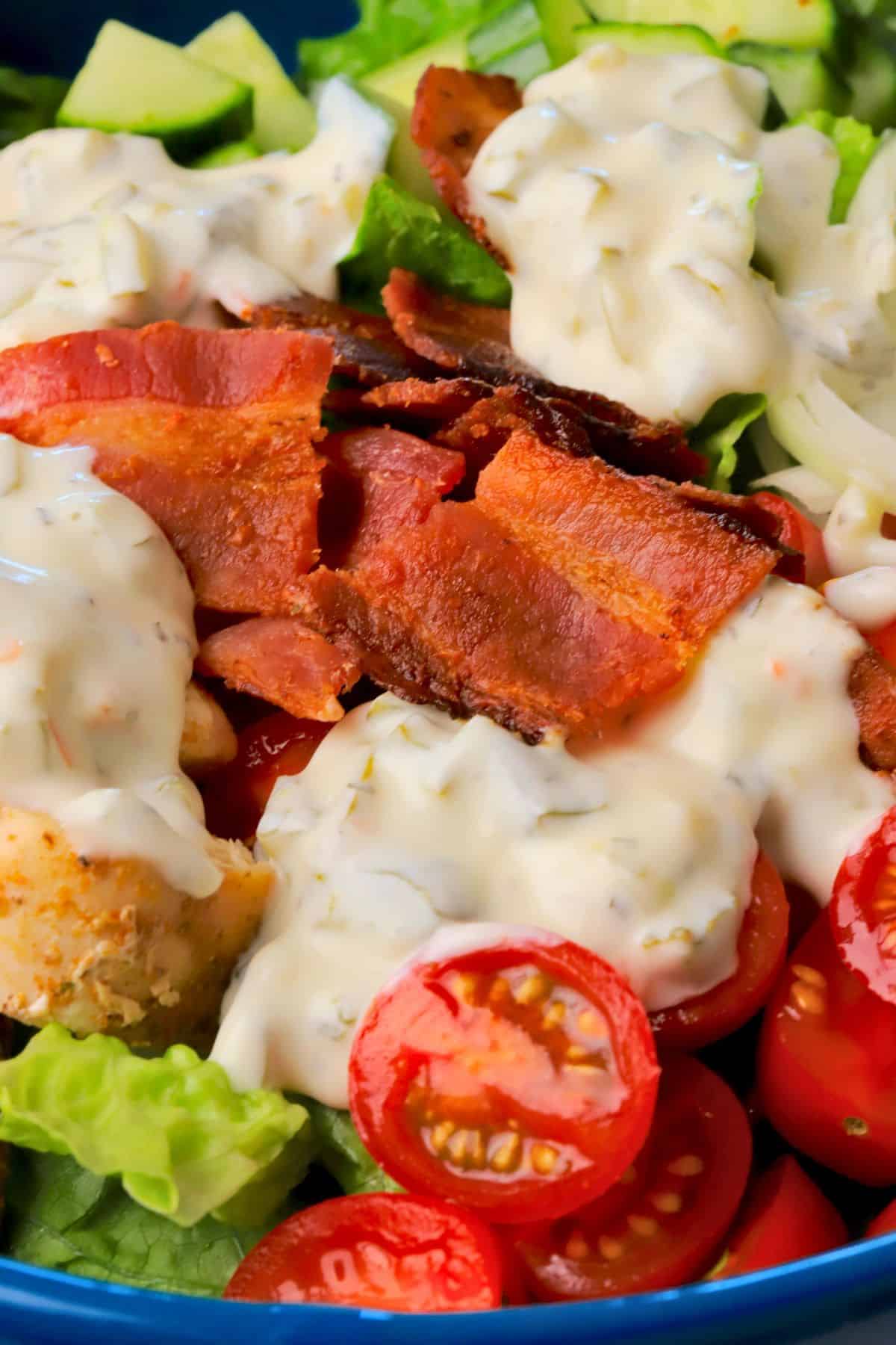 Close up of the loaded dill pickle bacon ranch chicken salad in a bowl.