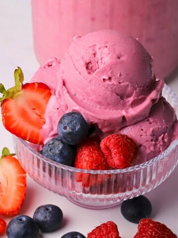 Ninja creami low carb triple berry ice cream in a bowl with fresh berries.
