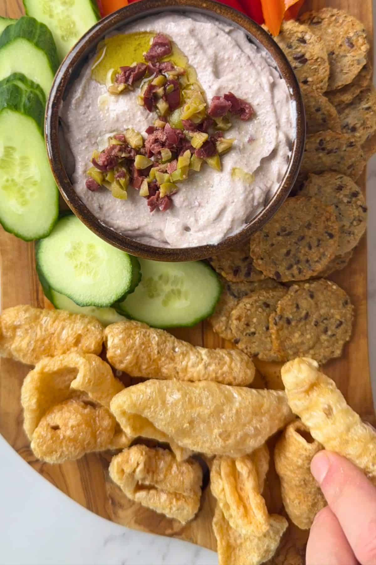 Laying ingredients around the bowl on a platter.