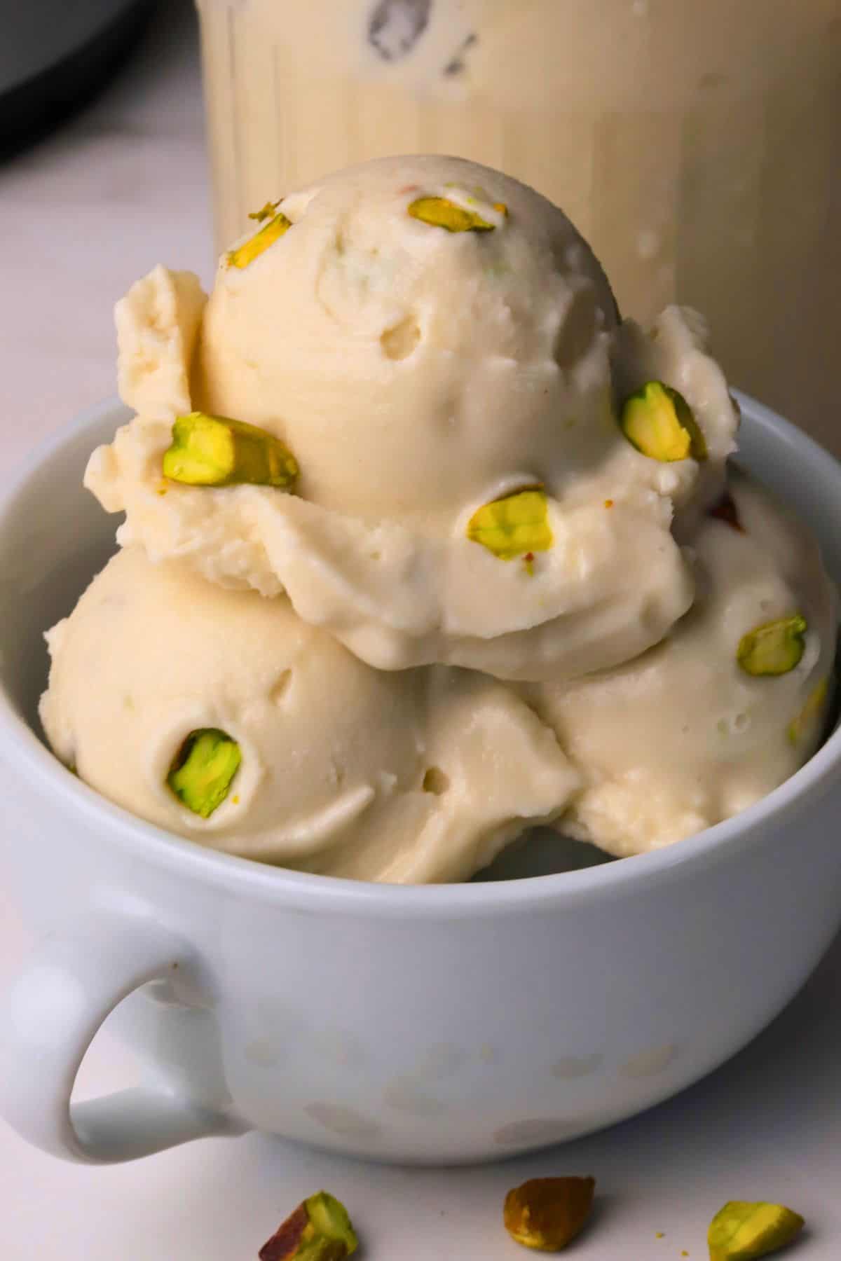 Low carb pistachio almond ice cream in a white bowl.