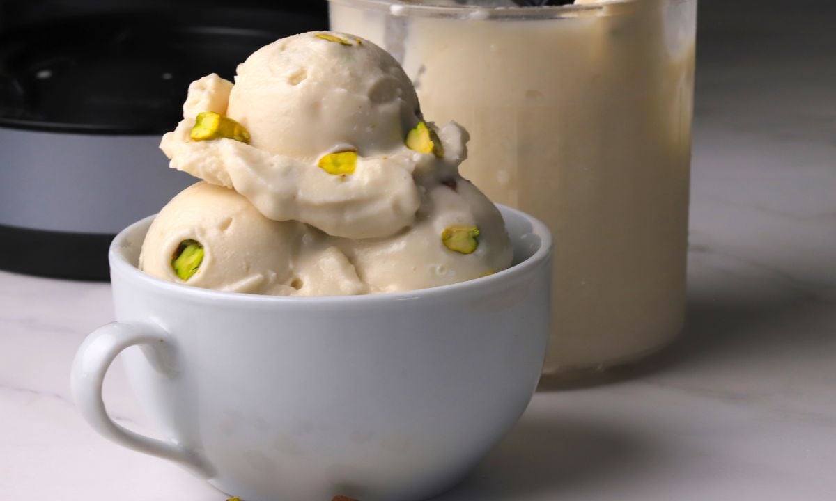 Low carb pistachio almond ice cream in a white bowl.