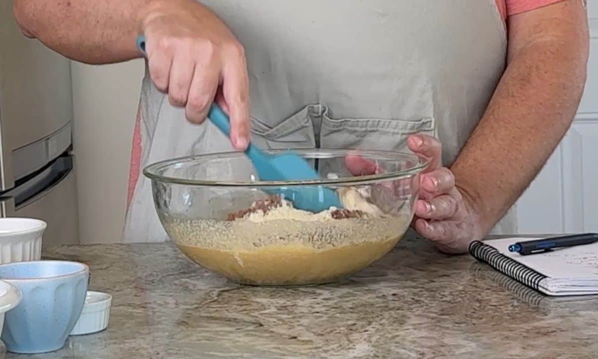 Mixing the batter in a bowl with a rubber spatula.