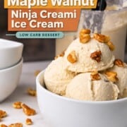 Scoops of low carb maple walnut ice cream in a bowl topped with walnut pieces next to the ninja creami pint.