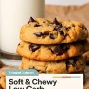 Low carb chocolate chip cookies stacked on top of each other next to a glass of milk.