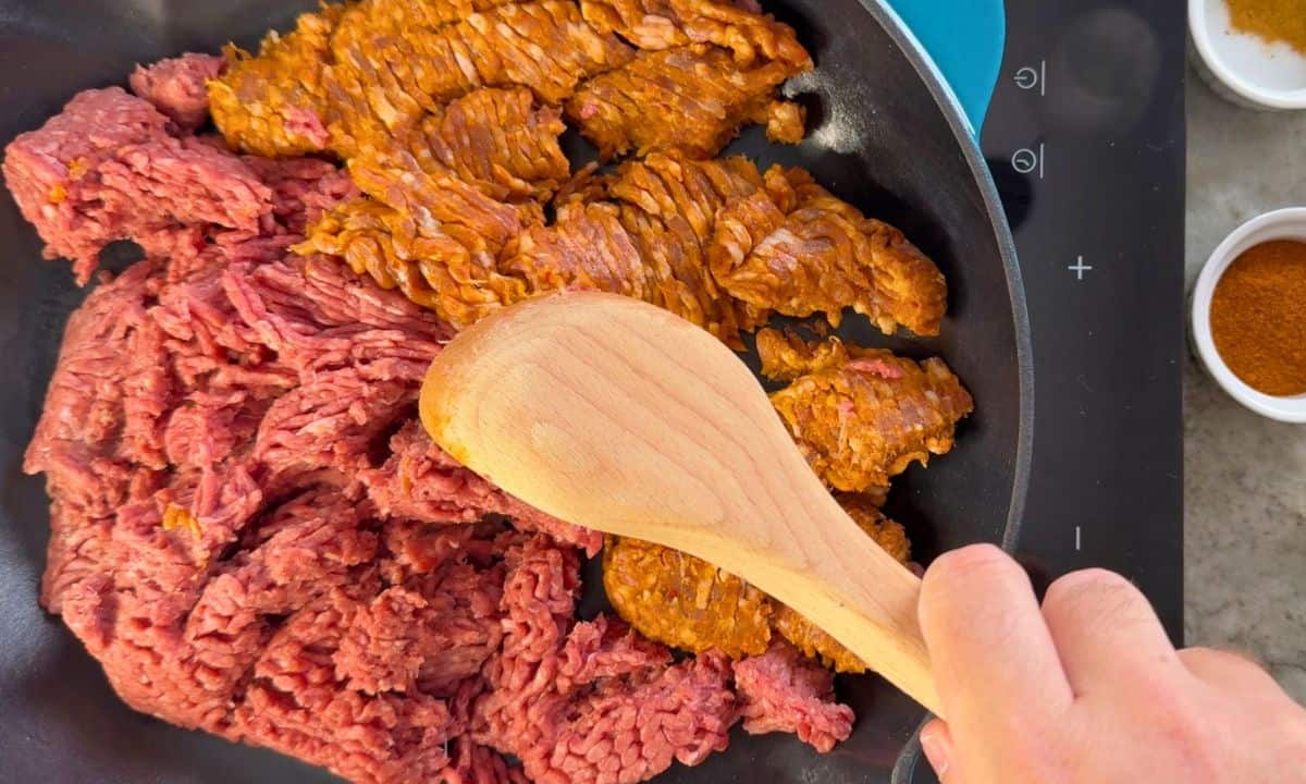 Browning the ground meat in the skillet.