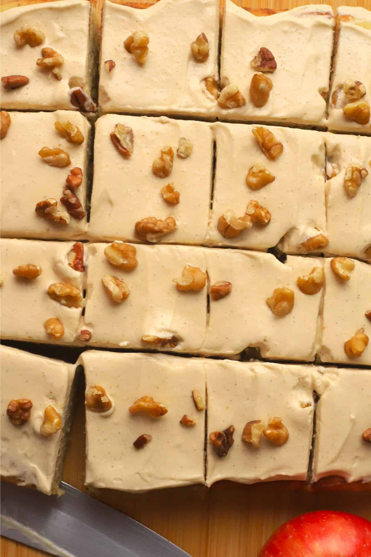Low carb apple spice cake cut into squares next to an apple.