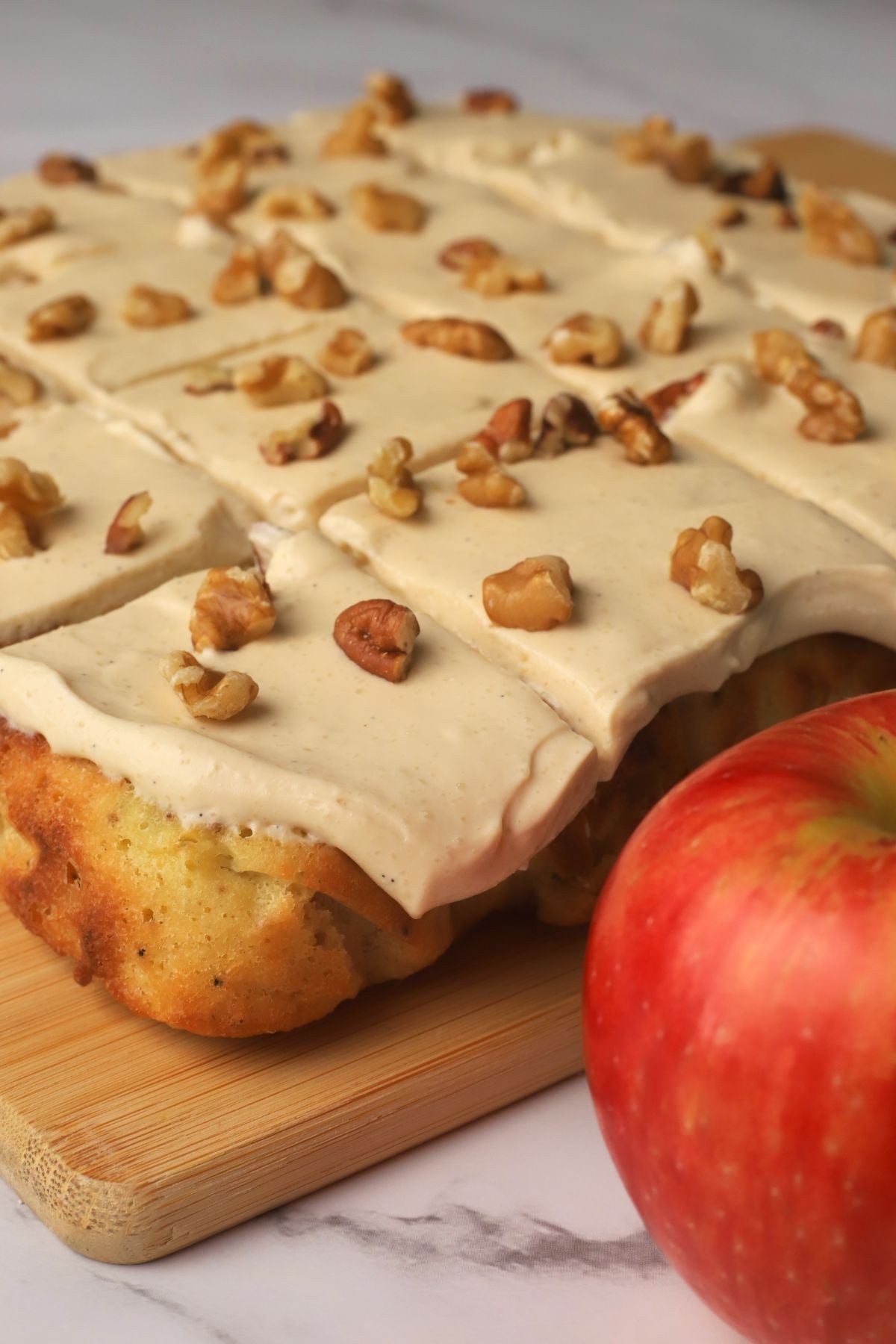 Low carb apple spice cake cut into squares next to an apple.