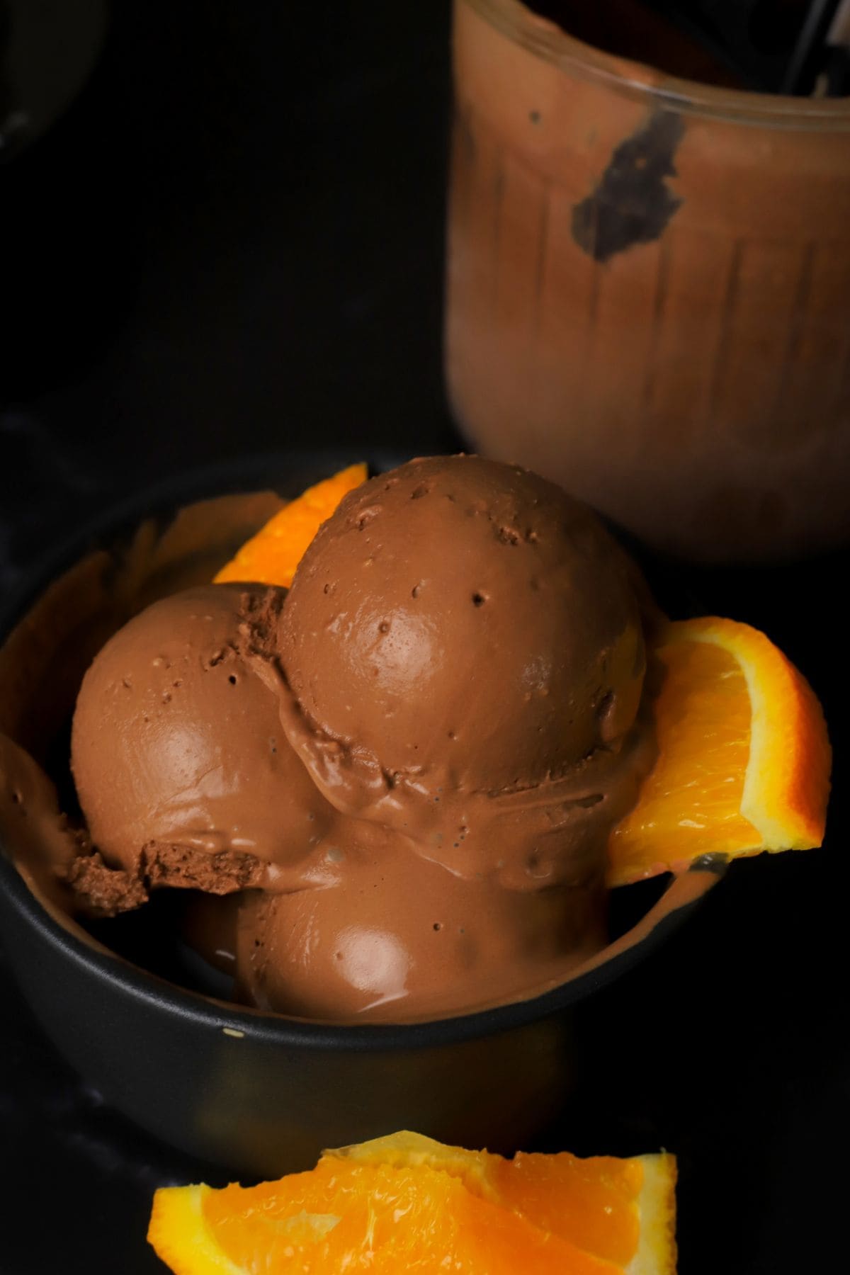 Scoops of low carb chocolate orange ice cream in a bowl.