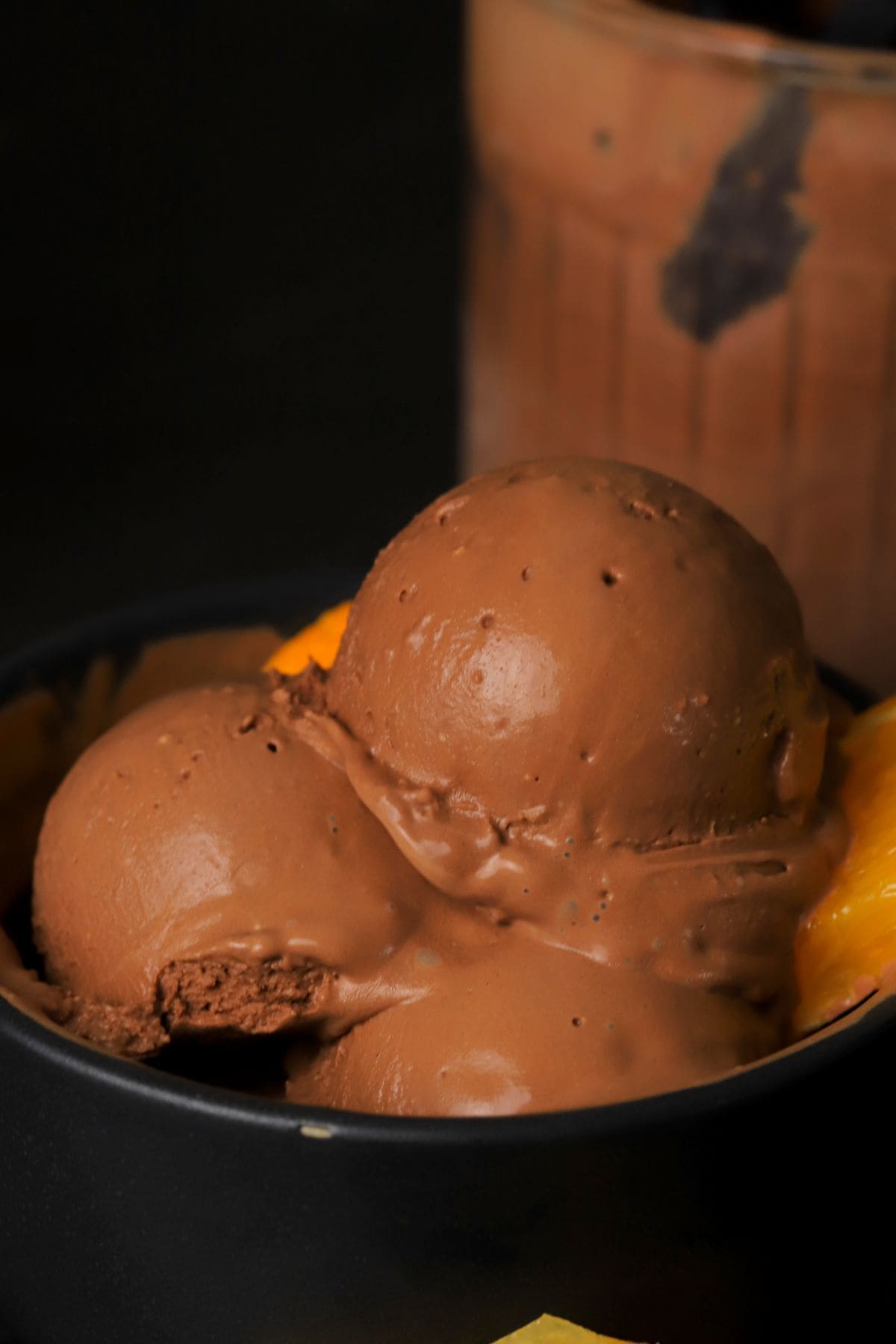 Scoops of low carb chocolate orange ice cream in a bowl.