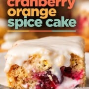 Closeup of a square of the low carb cranberry orange spice cake on a plate with a fork.