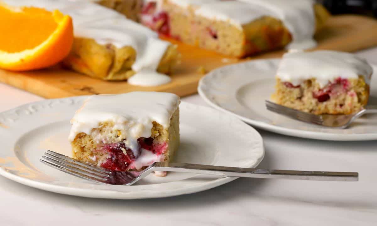 Squares of the low carb cranberry orange spice cake on a plates.