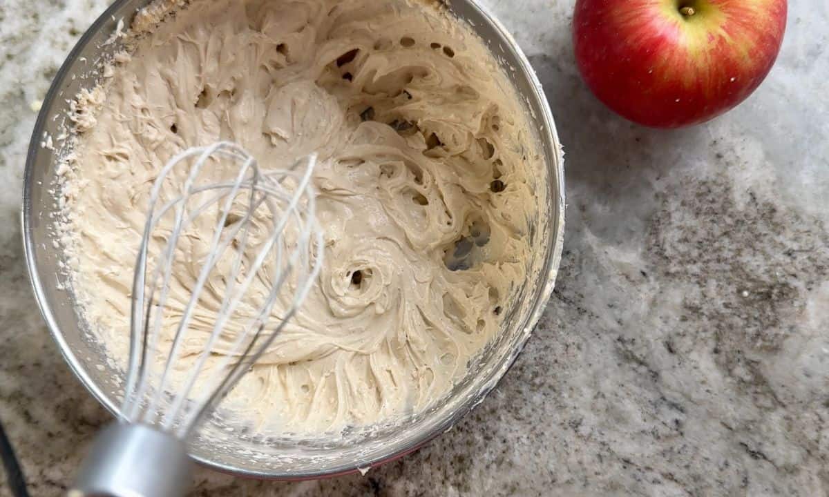 Beating the frosting in a bowl.