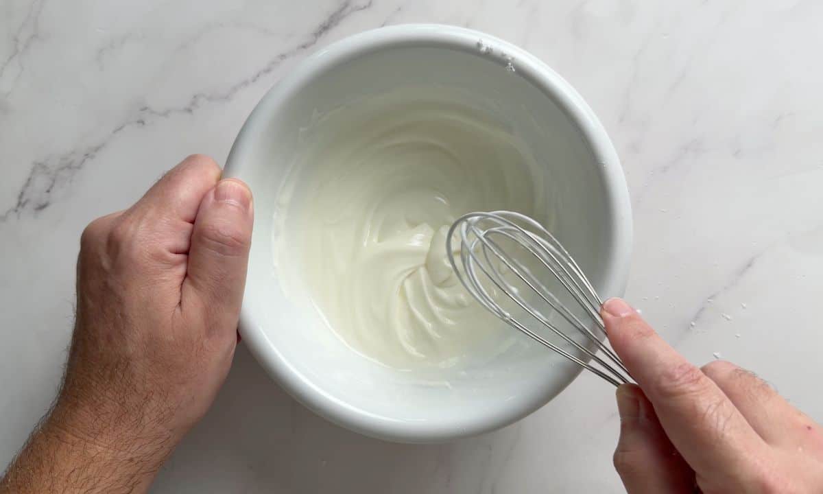 Whisking the glaze in the bowl.