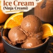 Scoops of low carb chocolate orange ninja creami ice cream in a bowl with orange segments.