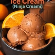 Scoops of low carb chocolate orange ninja creami ice cream in a bowl with orange segments.