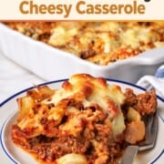 A slice of the low carb italian beef and cabbage cheesy casserole on a plate next to the casserole dish.