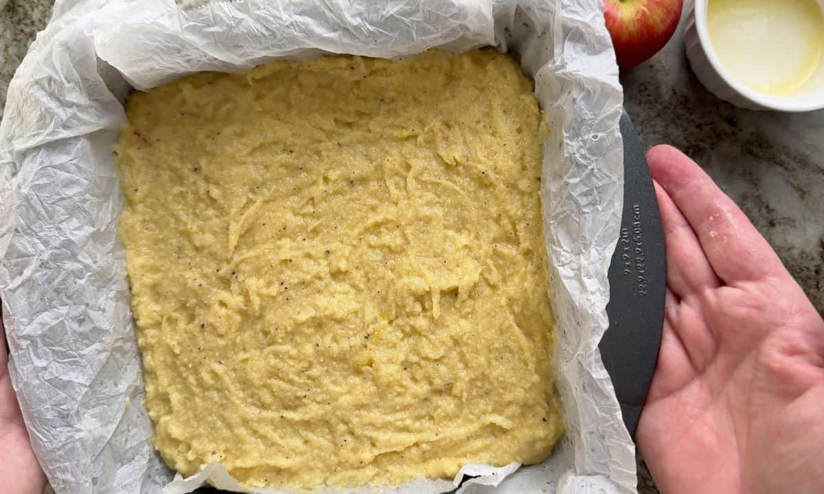 Cake batter in the parchment lined baking pan.