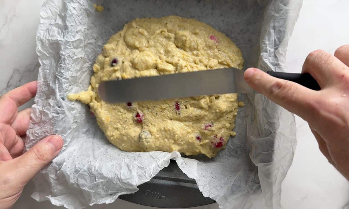 Spreading the cake batter in the baking pan.
